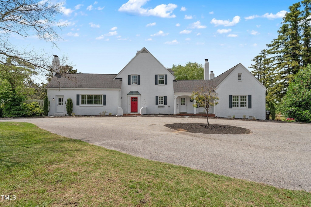 70 S Patterson St, Coats, NC 27521 - traditional-style home featuring a chimney, a front yard, and a shingled roof
