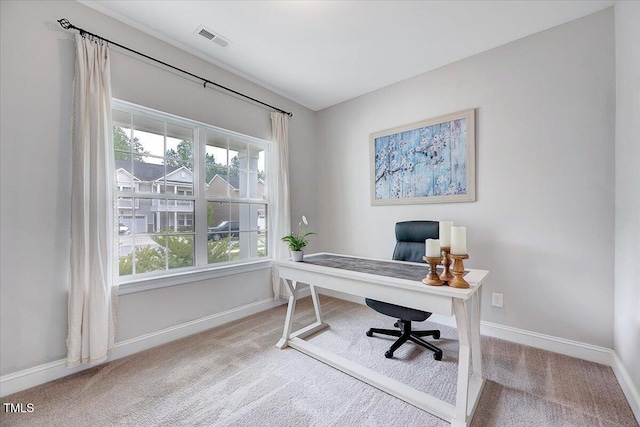 carpeted office featuring baseboards
