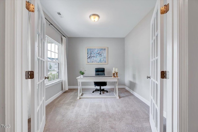 carpeted office with french doors and baseboards