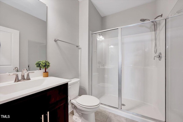 full bathroom with a stall shower, toilet, tile patterned floors, and vanity