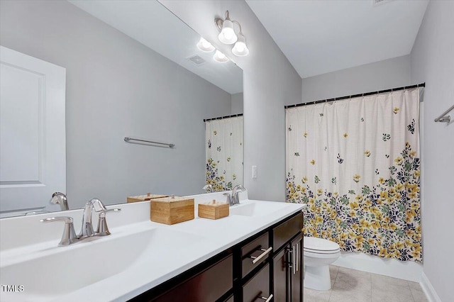bathroom with toilet, double vanity, tile patterned floors, and shower / bath combo with shower curtain