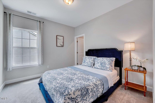 bedroom with carpet floors and baseboards