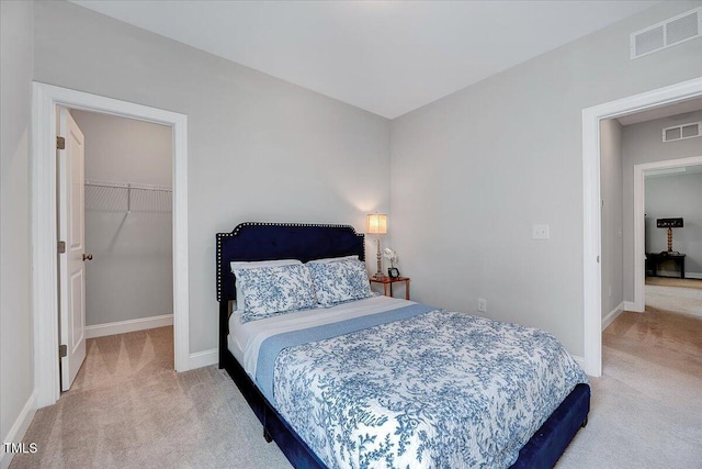 bedroom featuring carpet floors, a spacious closet, baseboards, and a closet