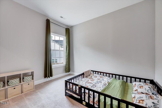 bedroom with carpet floors and baseboards