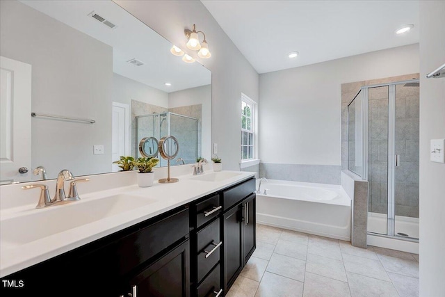 bathroom featuring a bath, a shower stall, double vanity, and tile patterned floors