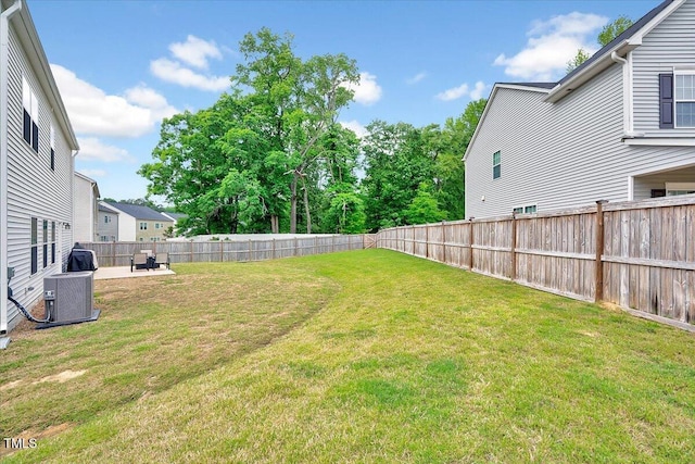 view of yard featuring central AC unit and a patio