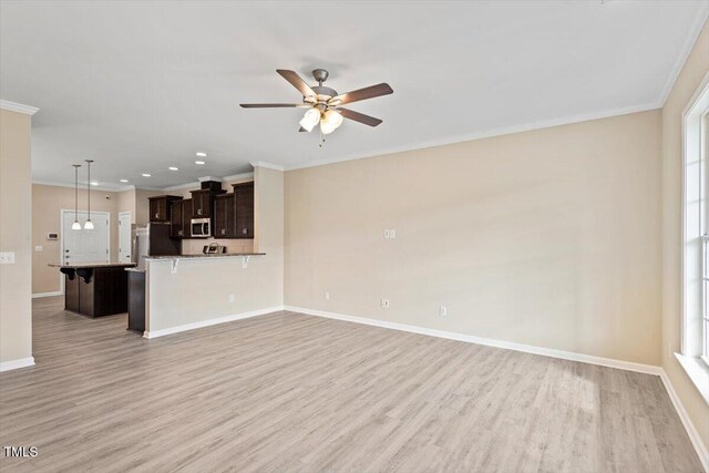 1027 Myers Point Dr, Morrisville, NC 27560 - unfurnished living room featuring light wood-style floors, a ceiling fan, crown molding, baseboards, and recessed lighting