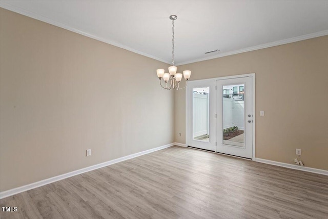 1027 Myers Point Dr, Morrisville, NC 27560 - spare room featuring wood finished floors, a chandelier, crown molding, and baseboards