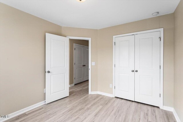1027 Myers Point Dr, Morrisville, NC 27560 - unfurnished bedroom with light wood-style flooring, baseboards, and a closet