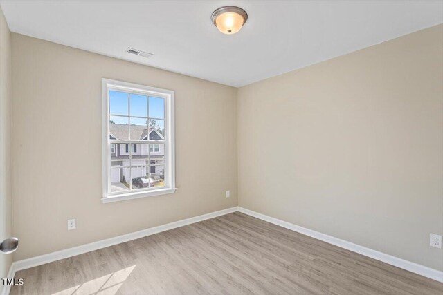 1027 Myers Point Dr, Morrisville, NC 27560 - spare room featuring wood finished floors and baseboards