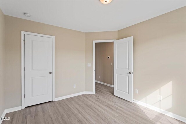 1027 Myers Point Dr, Morrisville, NC 27560 - spare room with light wood finished floors, baseboards, and a smoke detector