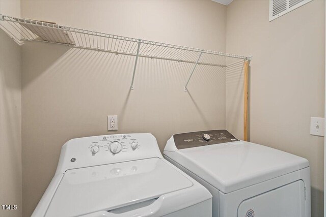 1027 Myers Point Dr, Morrisville, NC 27560 - clothes washing area with washing machine and clothes dryer