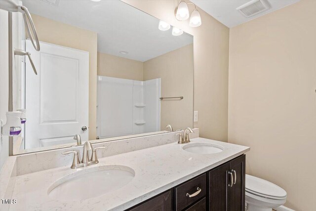 1027 Myers Point Dr, Morrisville, NC 27560 - full bathroom with toilet, double vanity, and a shower
