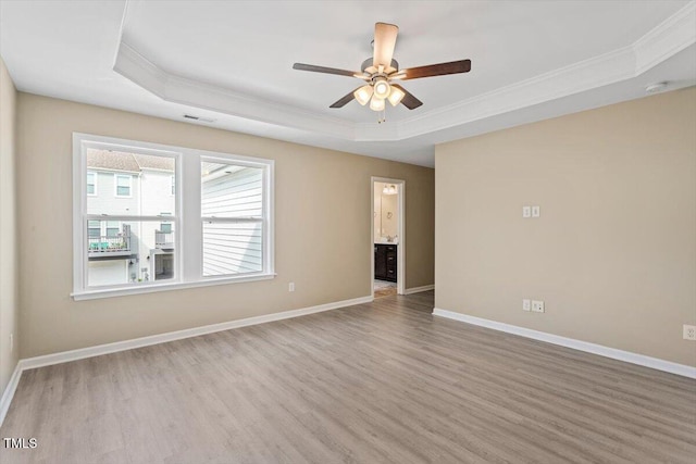 1027 Myers Point Dr, Morrisville, NC 27560 - spare room featuring a tray ceiling, ornamental molding, wood finished floors, a ceiling fan, and baseboards