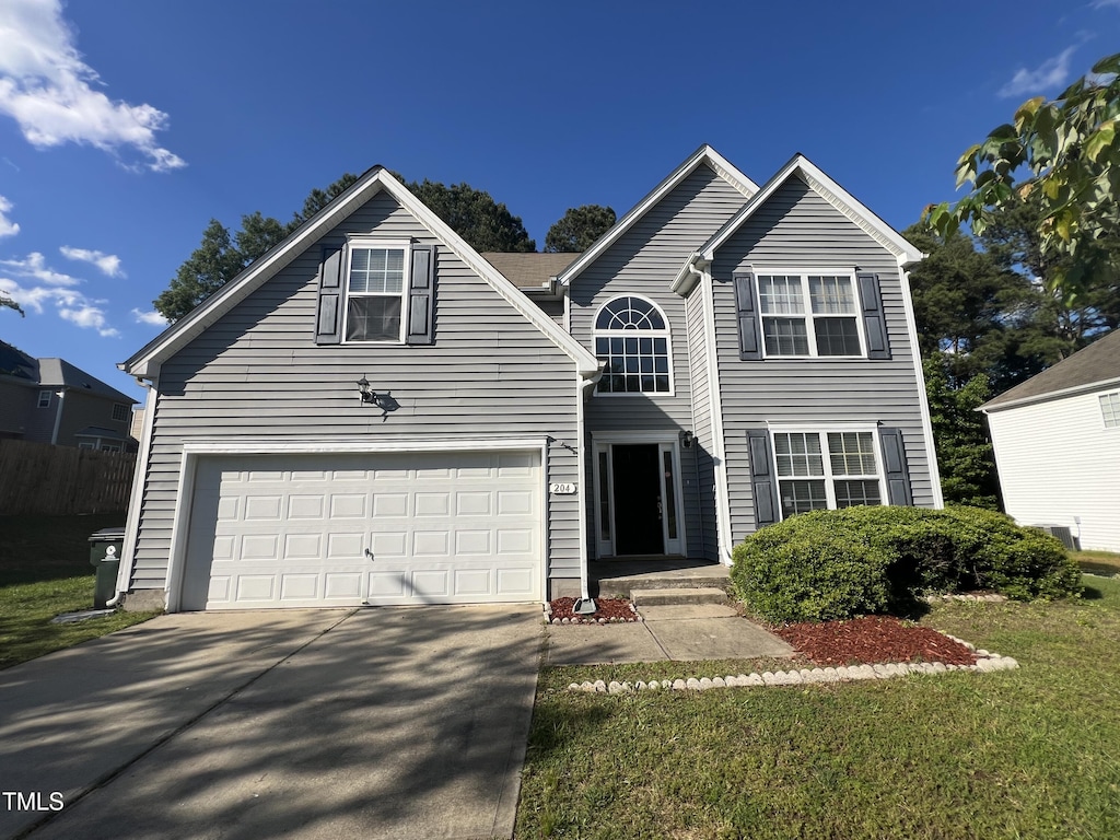 traditional home featuring concrete driveway, a garage, and a front lawn