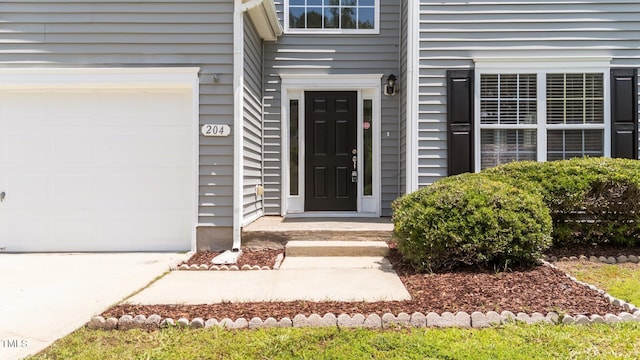 204 Trevor Ridge Dr, Holly Springs, NC 27540 - view of exterior entry featuring a garage