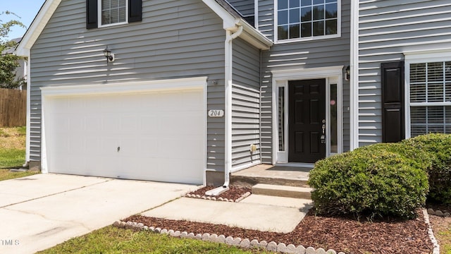 204 Trevor Ridge Dr, Holly Springs, NC 27540 - entrance to property with a garage and driveway