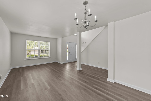 204 Trevor Ridge Dr, Holly Springs, NC 27540 - unfurnished living room featuring wood finished floors and a chandelier
