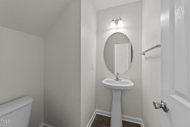 204 Trevor Ridge Dr, Holly Springs, NC 27540 - half bathroom featuring toilet and wood finished floors