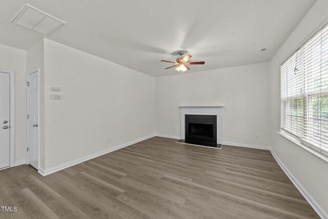 204 Trevor Ridge Dr, Holly Springs, NC 27540 - unfurnished living room with a ceiling fan, a fireplace, and wood finished floors