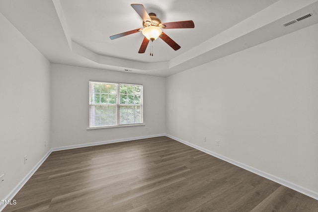 204 Trevor Ridge Dr, Holly Springs, NC 27540 - spare room featuring a tray ceiling, dark wood-type flooring, and a ceiling fan