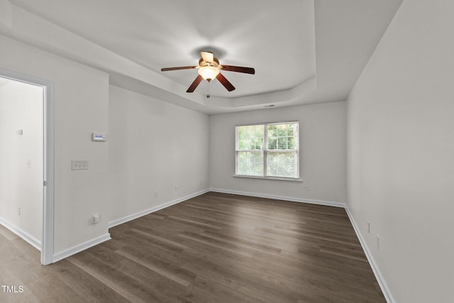 204 Trevor Ridge Dr, Holly Springs, NC 27540 - unfurnished room with ceiling fan, a tray ceiling, and dark wood-type flooring