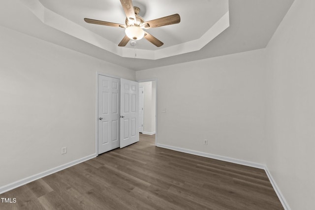204 Trevor Ridge Dr, Holly Springs, NC 27540 - unfurnished bedroom with a tray ceiling, wood finished floors, and a ceiling fan
