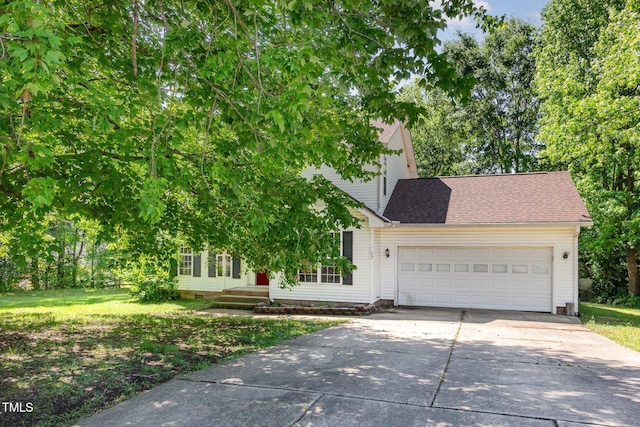 105 Hiddenwood Ct, Garner, NC 27529 - obstructed view of property featuring concrete driveway, an attached garage, a front yard, and roof with shingles