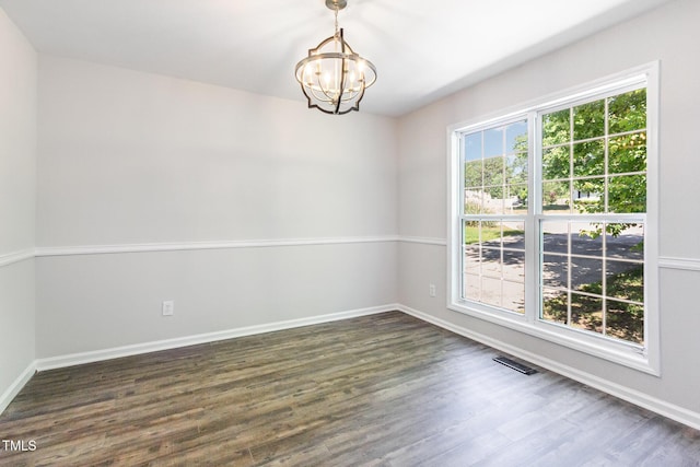 105 Hiddenwood Ct, Garner, NC 27529 - empty room with a chandelier, dark wood-style flooring, and baseboards
