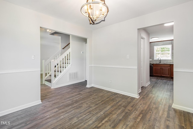 105 Hiddenwood Ct, Garner, NC 27529 - unfurnished room featuring a sink, dark wood finished floors, a chandelier, stairs, and baseboards