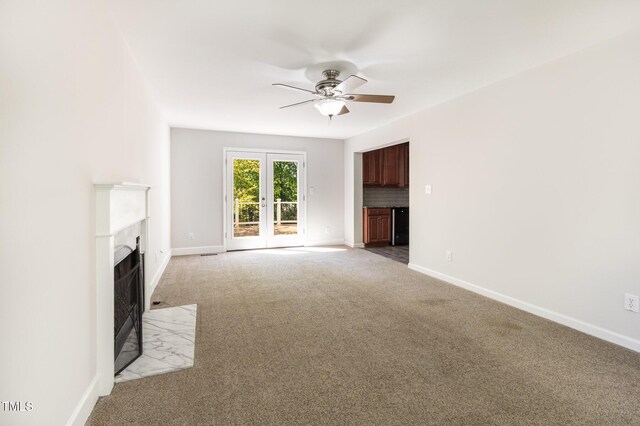 105 Hiddenwood Ct, Garner, NC 27529 - unfurnished living room with a ceiling fan, a fireplace with flush hearth, light colored carpet, and baseboards