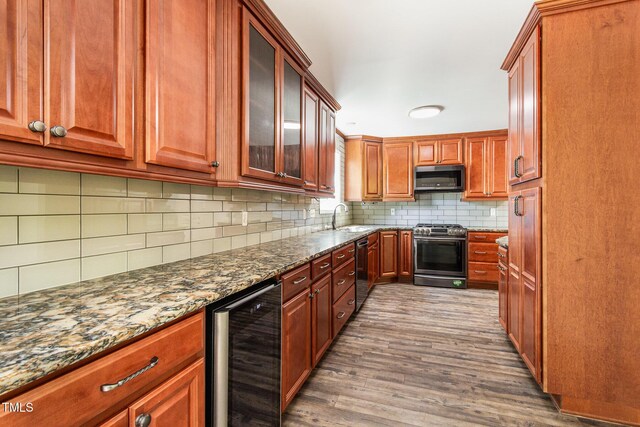 105 Hiddenwood Ct, Garner, NC 27529 - kitchen featuring beverage cooler, stainless steel appliances, a sink, dark wood-type flooring, and dark stone countertops