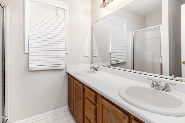 105 Hiddenwood Ct, Garner, NC 27529 - full bathroom featuring a stall shower, double vanity, and baseboards