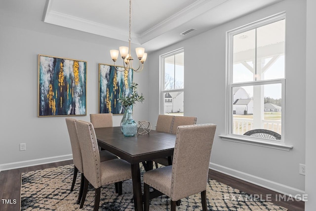 1412 Main St, Lillington, NC 27546 - dining space featuring a chandelier, ornamental molding, dark wood finished floors, a tray ceiling, and baseboards