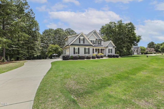 view of front of property with driveway, a garage, and a front yard