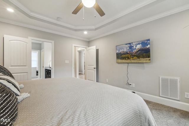 carpeted bedroom with a tray ceiling, ornamental molding, a ceiling fan, recessed lighting, and baseboards