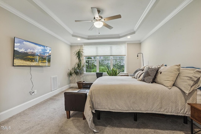 carpeted bedroom with a tray ceiling, baseboards, crown molding, a ceiling fan, and recessed lighting