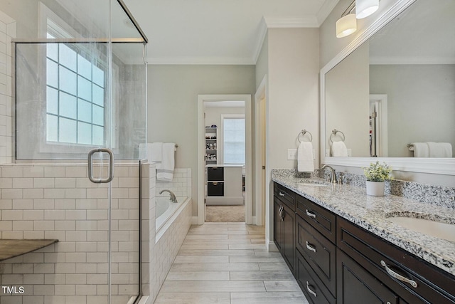 full bath with a shower stall, plenty of natural light, a garden tub, and crown molding