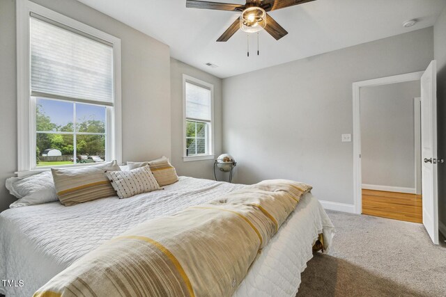 bedroom featuring carpet floors, baseboards, and ceiling fan