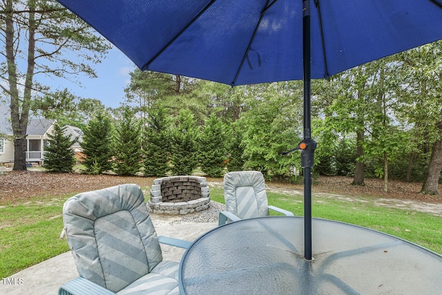 view of patio featuring outdoor dining space and a fire pit