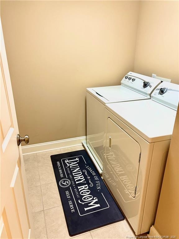 60 Hill Shore Ln, Clayton, NC 27527 - clothes washing area with washing machine and clothes dryer, tile patterned flooring, and baseboards