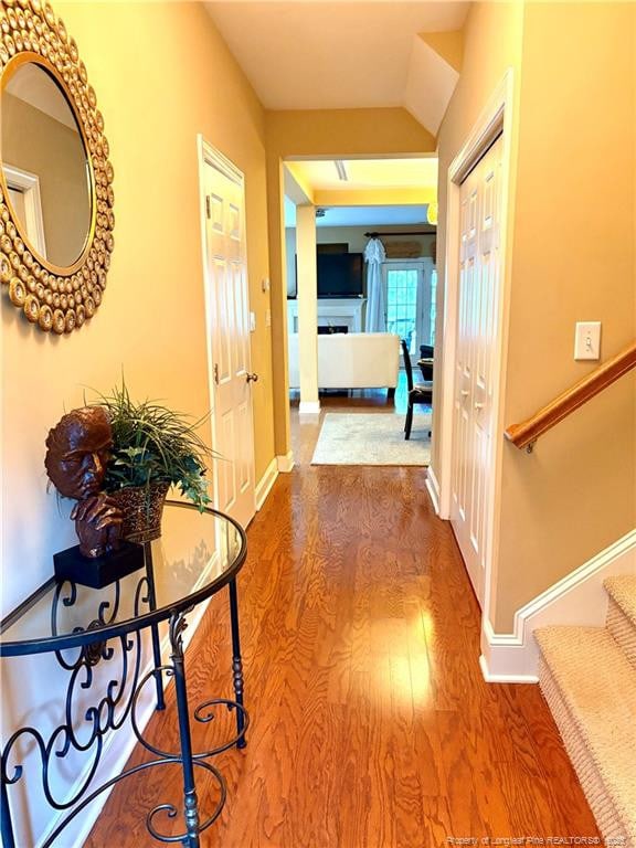 60 Hill Shore Ln, Clayton, NC 27527 - hall featuring stairs, wood finished floors, baseboards, and vaulted ceiling