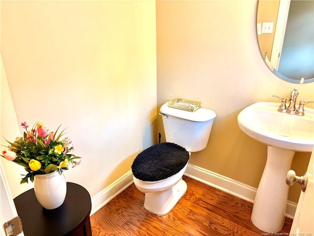 60 Hill Shore Ln, Clayton, NC 27527 - half bathroom with baseboards, toilet, wood finished floors, and a sink