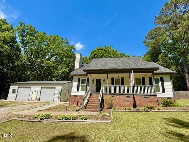view of front facade with crawl space, a porch, a garage, an outdoor structure, and a chimney