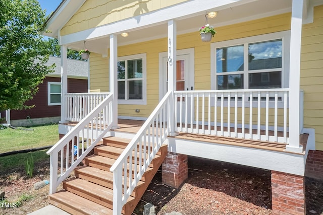 view of exterior entry with a porch