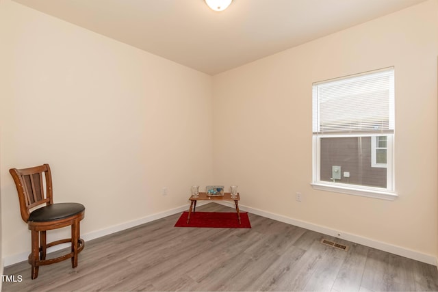 unfurnished room with light wood-style floors and baseboards