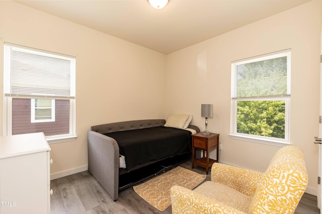 bedroom with light wood finished floors and baseboards