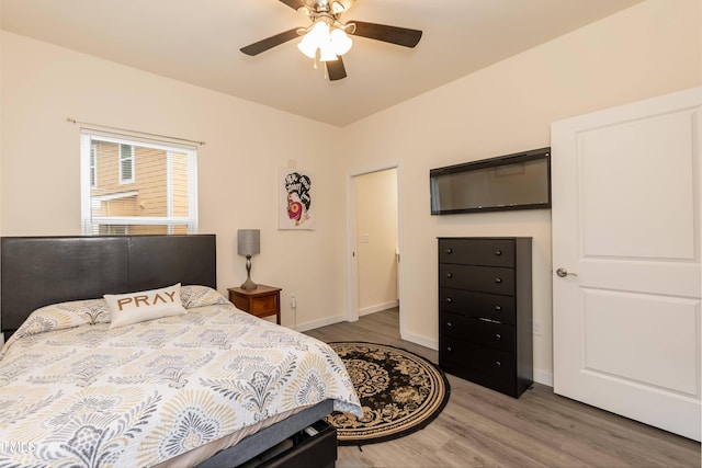 bedroom featuring wood finished floors, baseboards, and ceiling fan