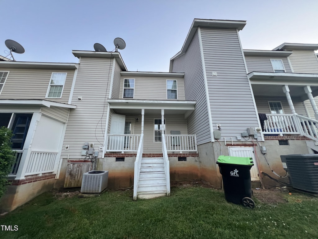 rear view of property featuring a porch, central air condition unit, stairs, and crawl space