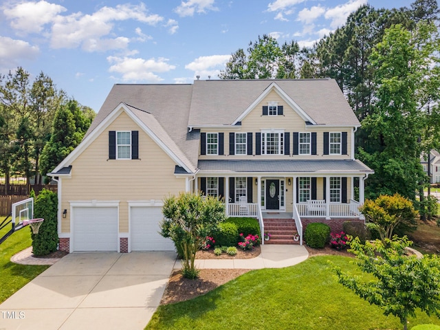 colonial inspired home featuring concrete driveway, a porch, and a garage